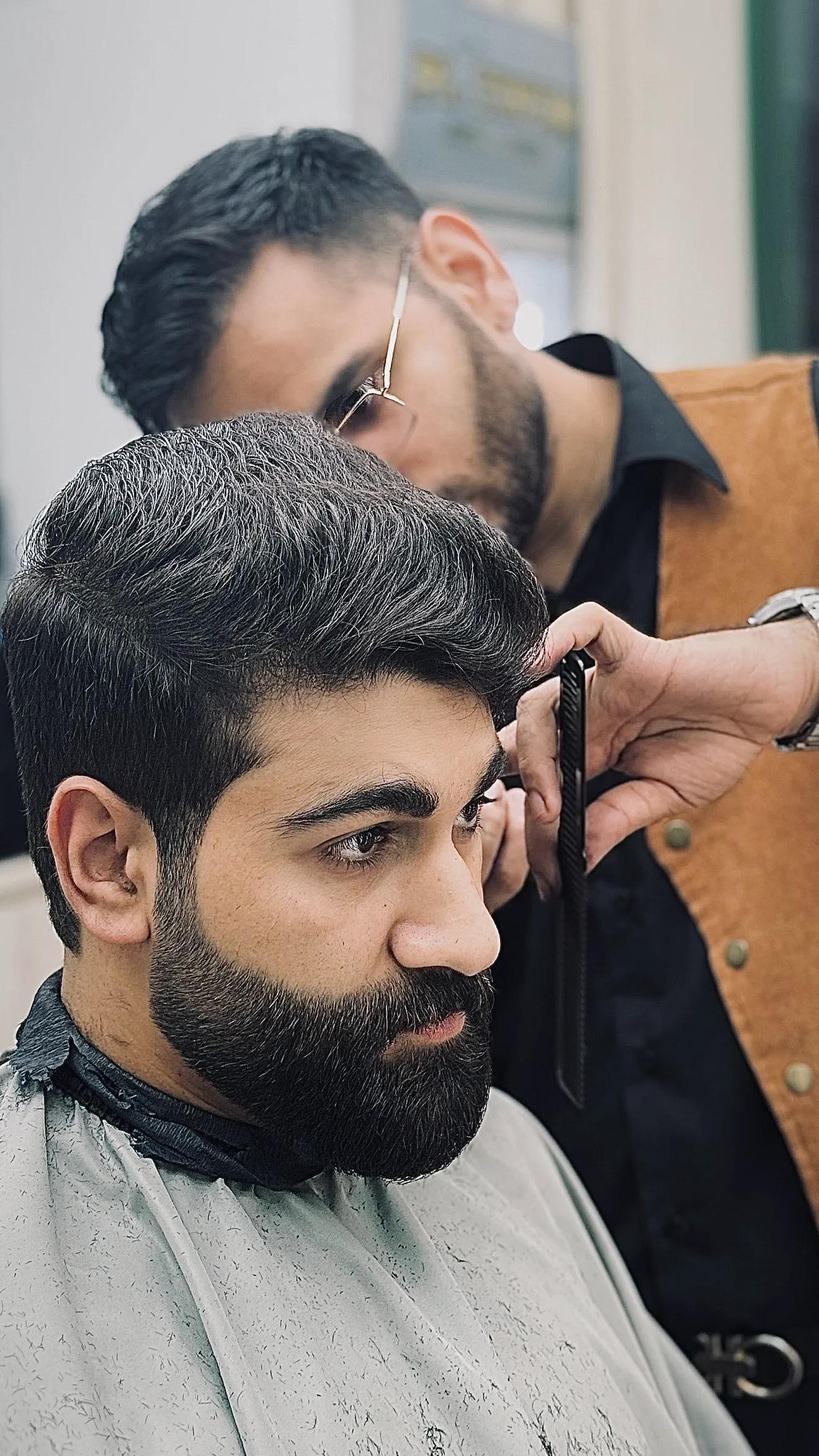 Barber giving precision haircut at Platinum Cutz Singapore